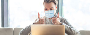 Satisfied guest with laptop and face mask